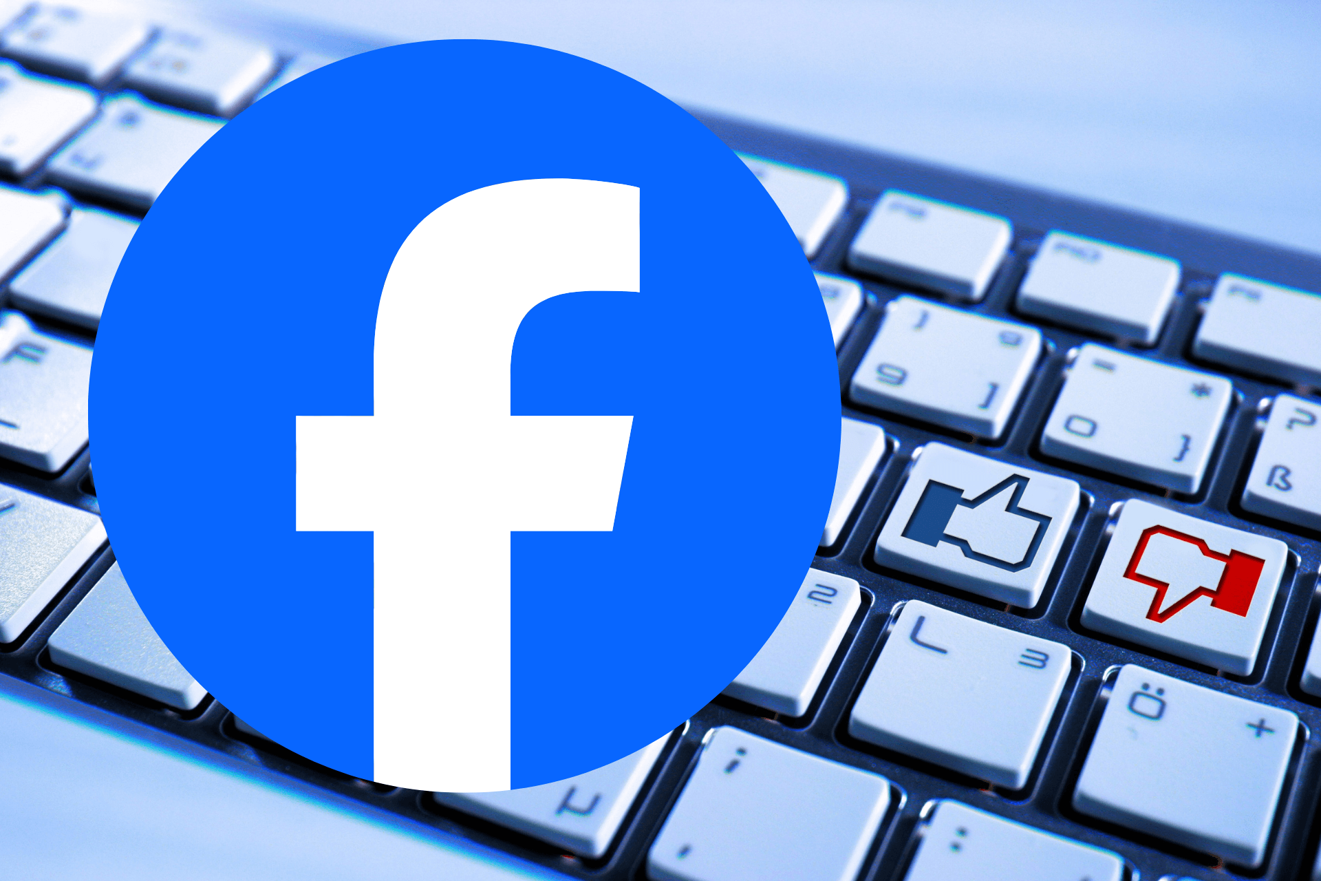 Facebook logo in front of a computer keyboard