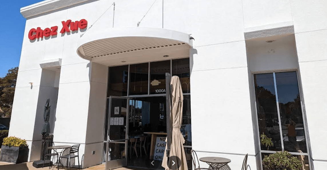 Chez Xue, a white restaurant with a red sign