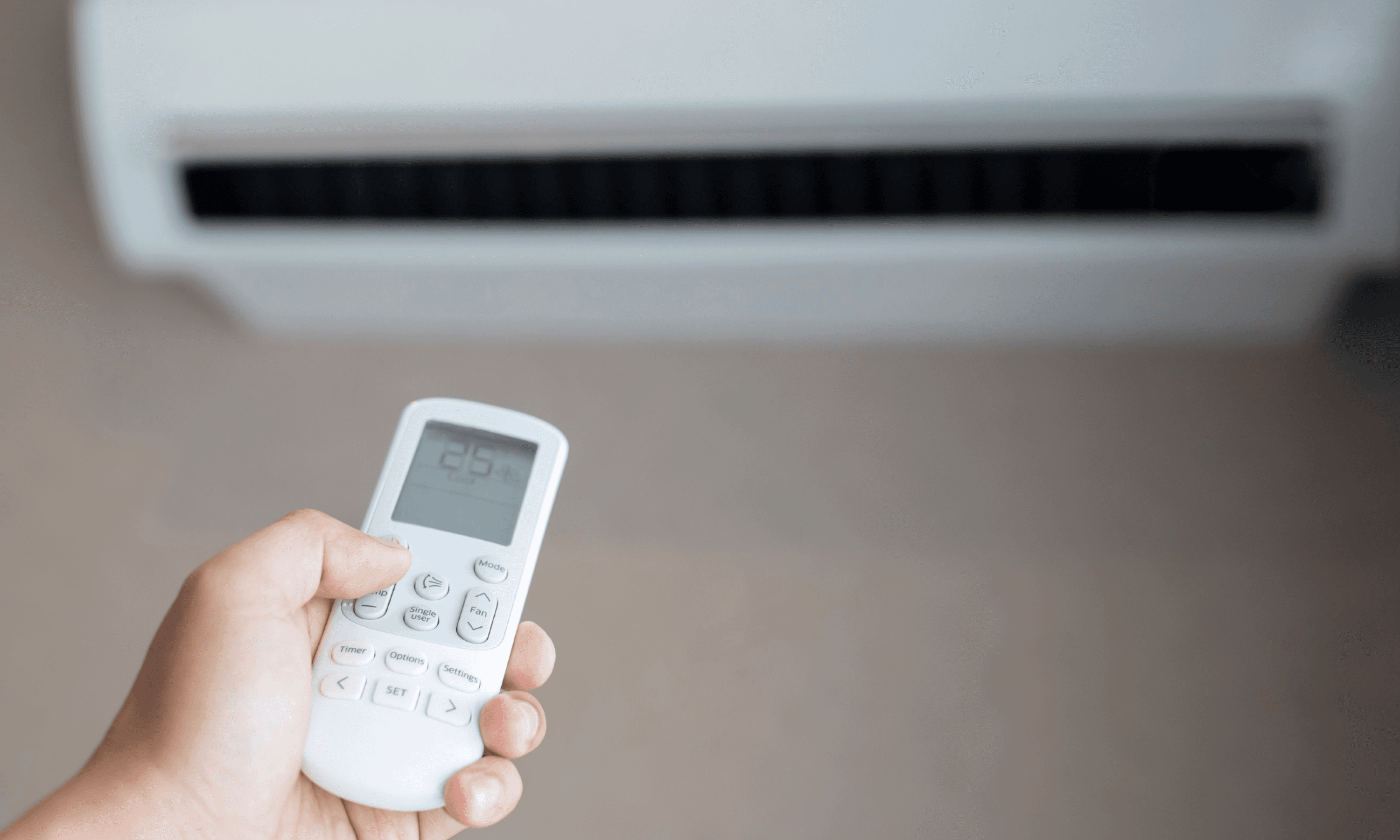 person adjusting an air conditioner