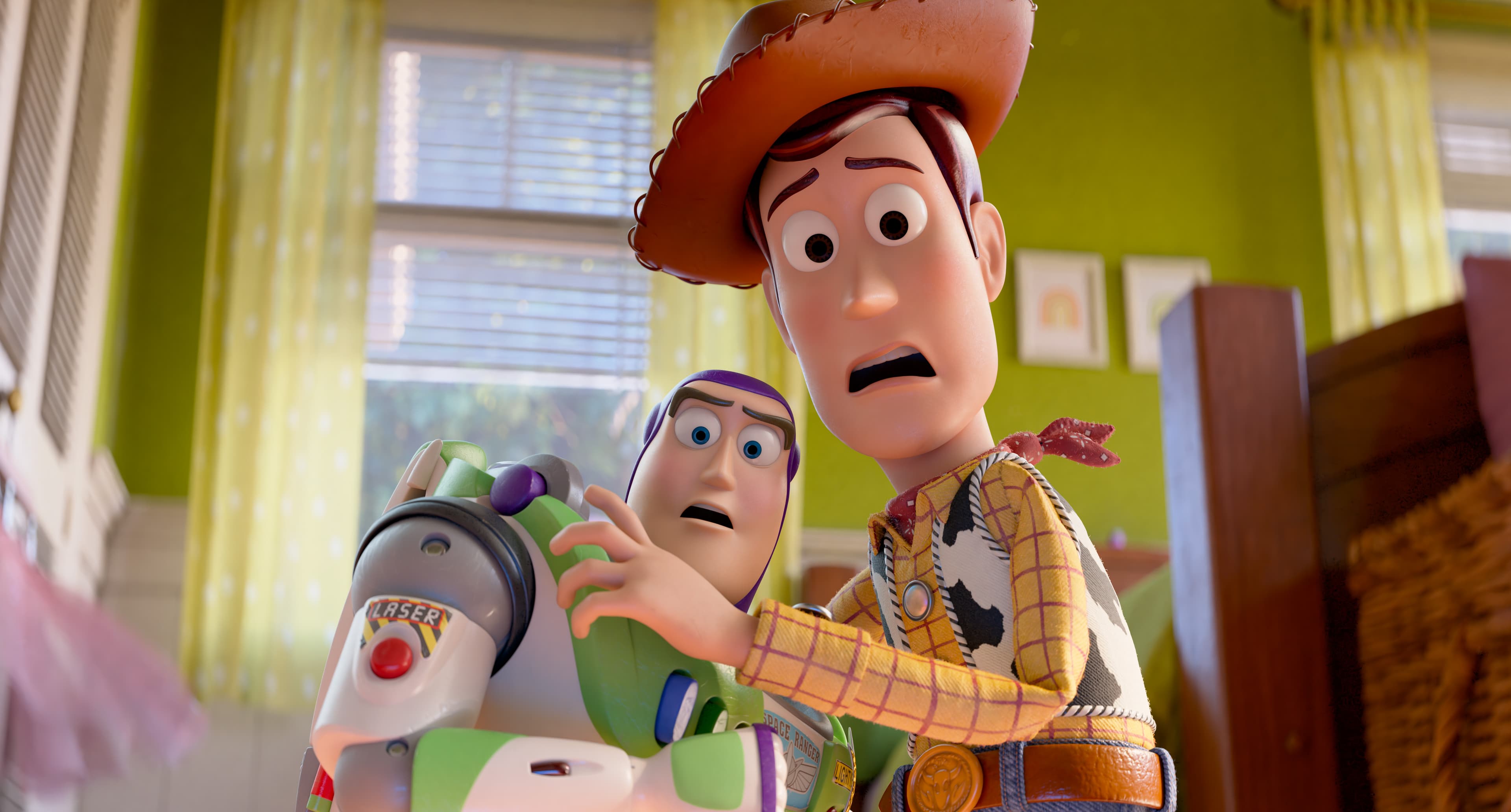 Buzz Lightyear, a toy space ranger, and Woody, a toy cowboy, look horrified at something in the distance.